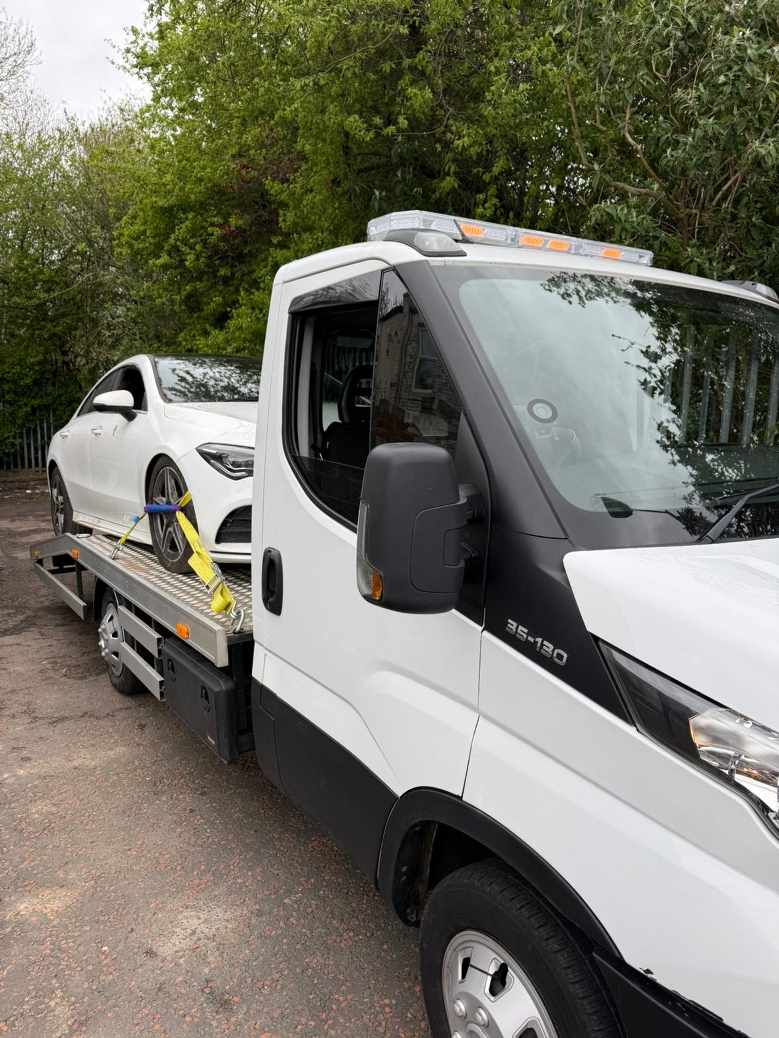 White Mercedes loaded for transport